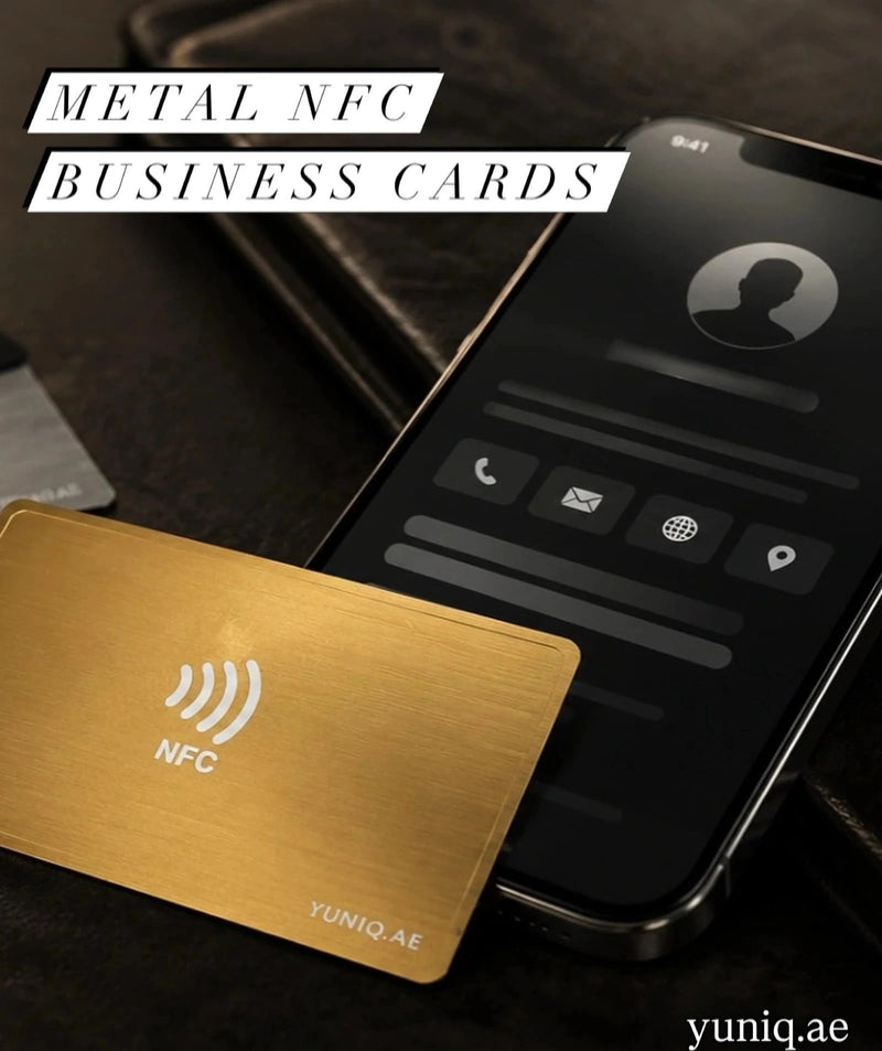 Metal NFC business card with YUNIQ.AE branding next to a smartphone